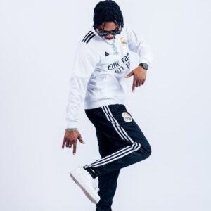 Stylish young man in Adidas sportswear striking a pose, full of energy and style.