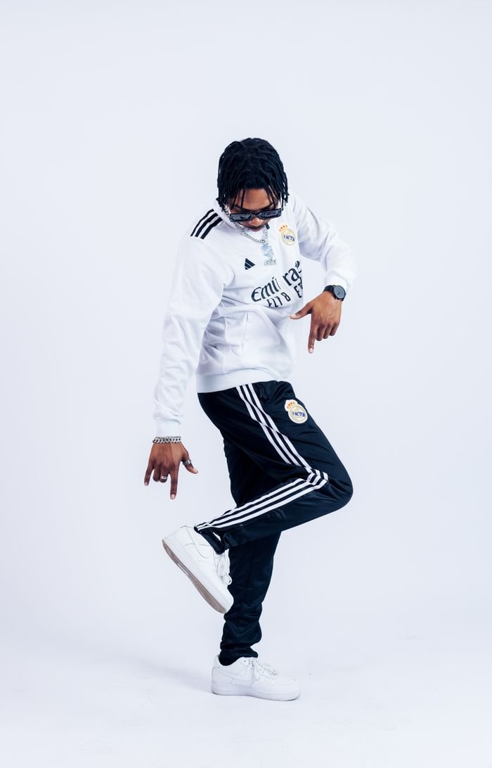 Stylish young man in Adidas sportswear striking a pose, full of energy and style.